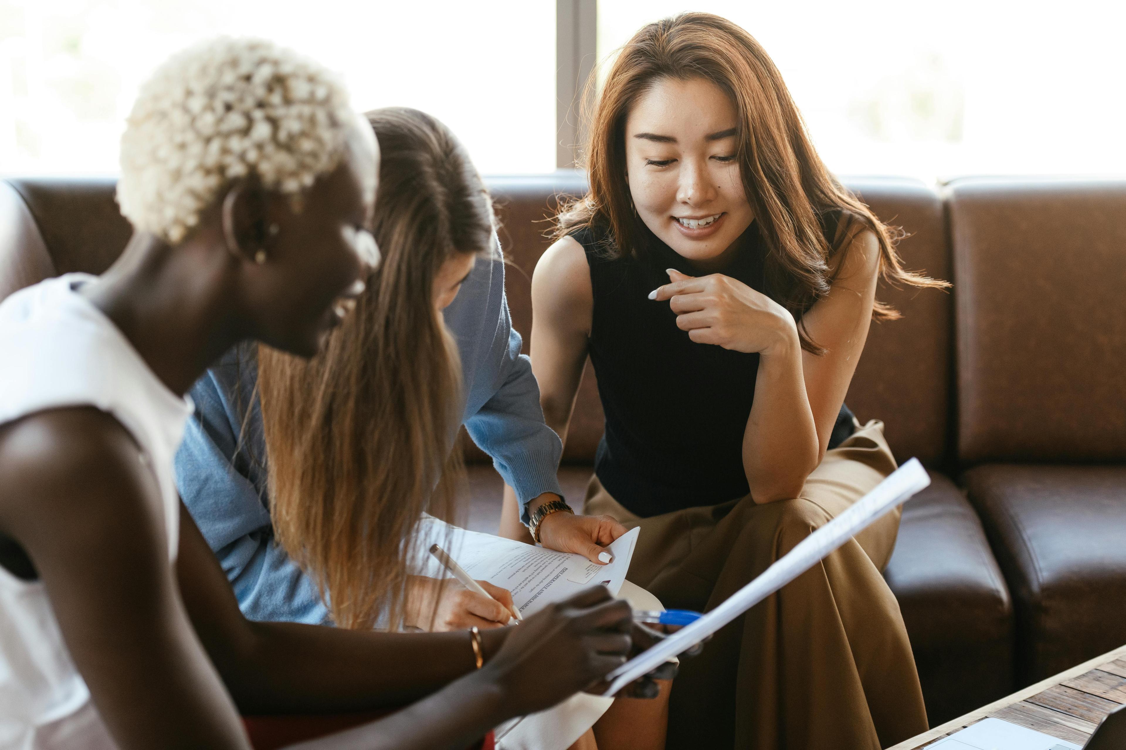 diverse group of young students review a resume together