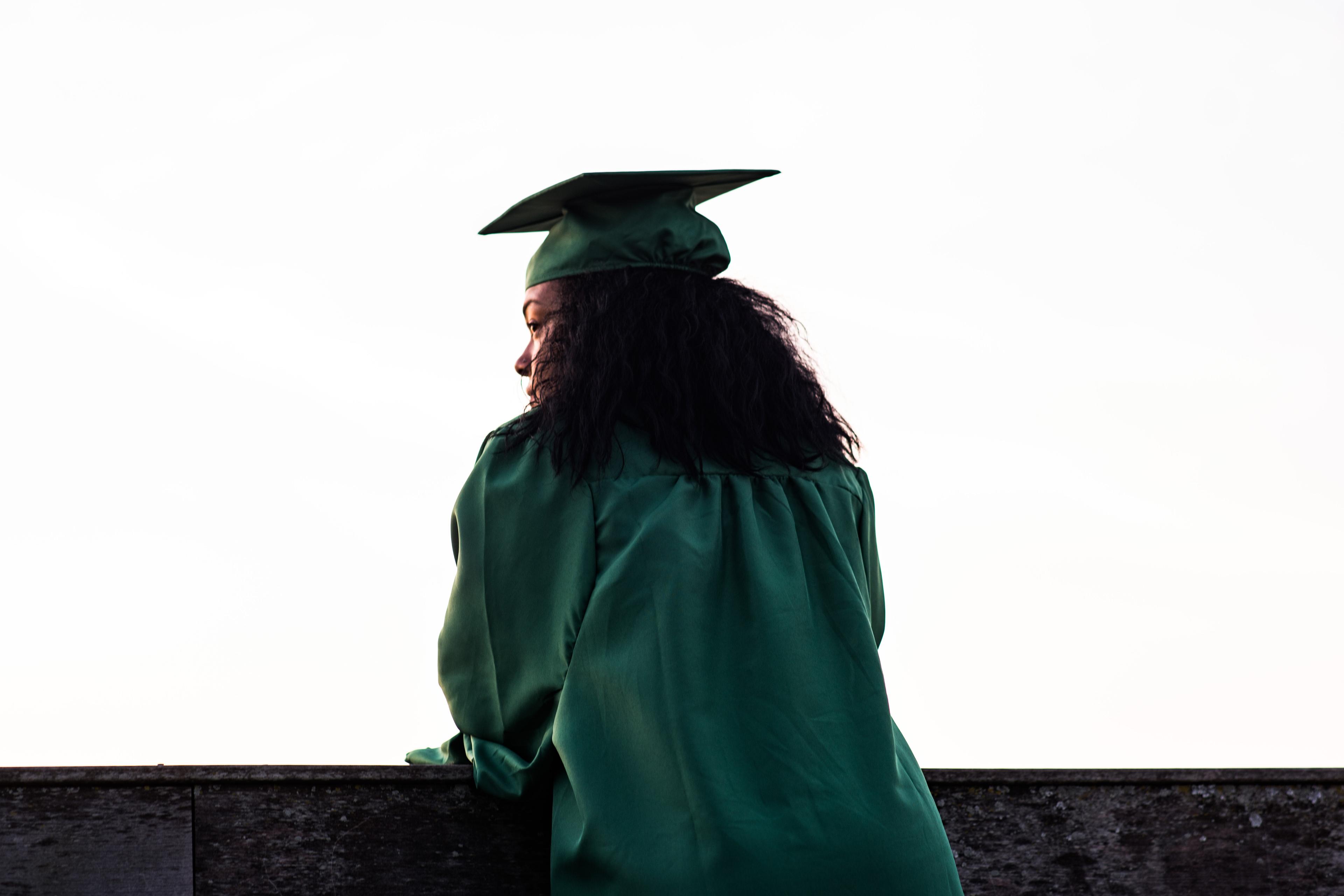 Graduating college student looks into the distance